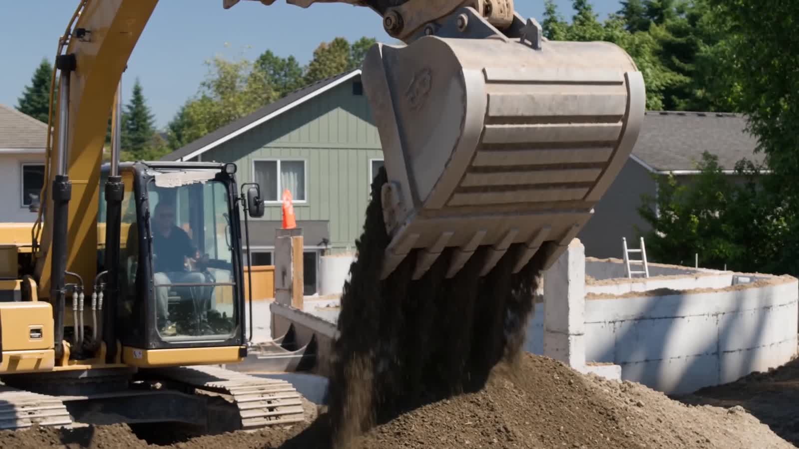 Excavator at the Mill Creek pad pouring fill