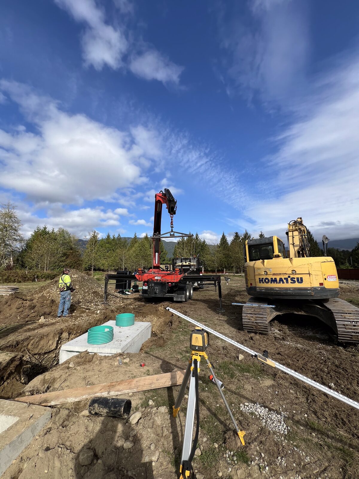 Septic tanks being set with a crane truck
