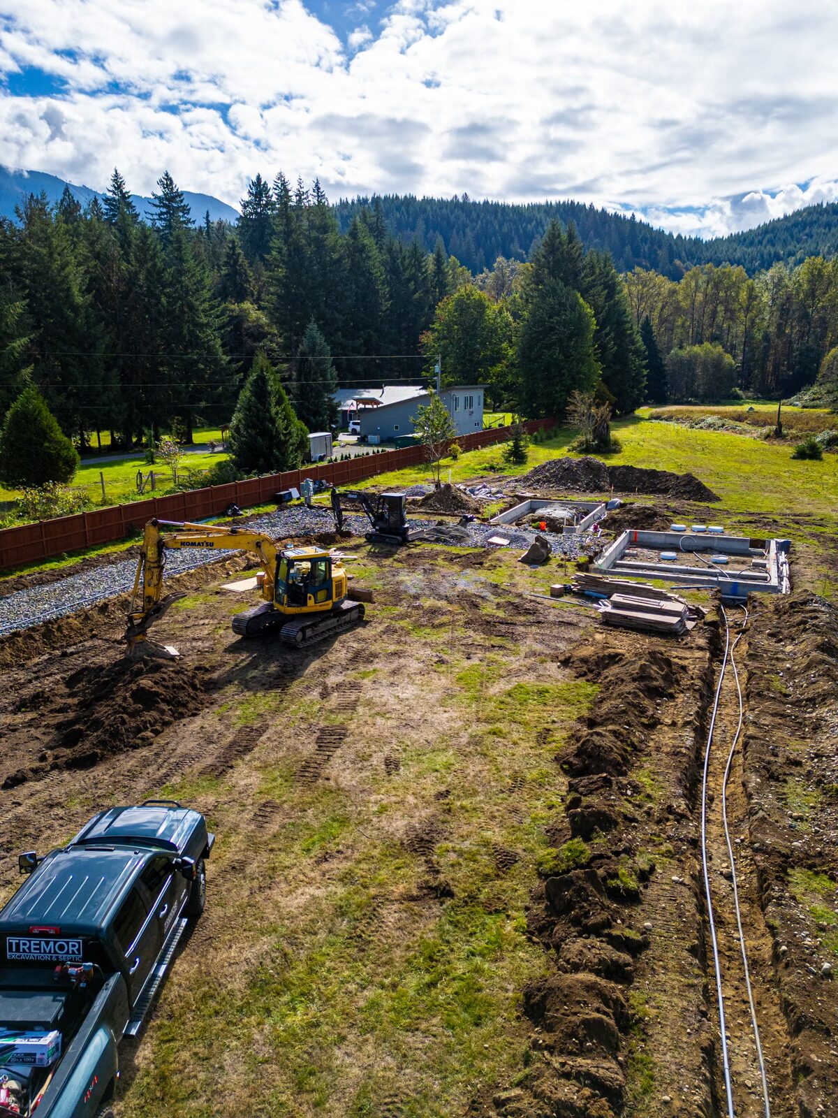 Tremor jobsite with company truck and excavator