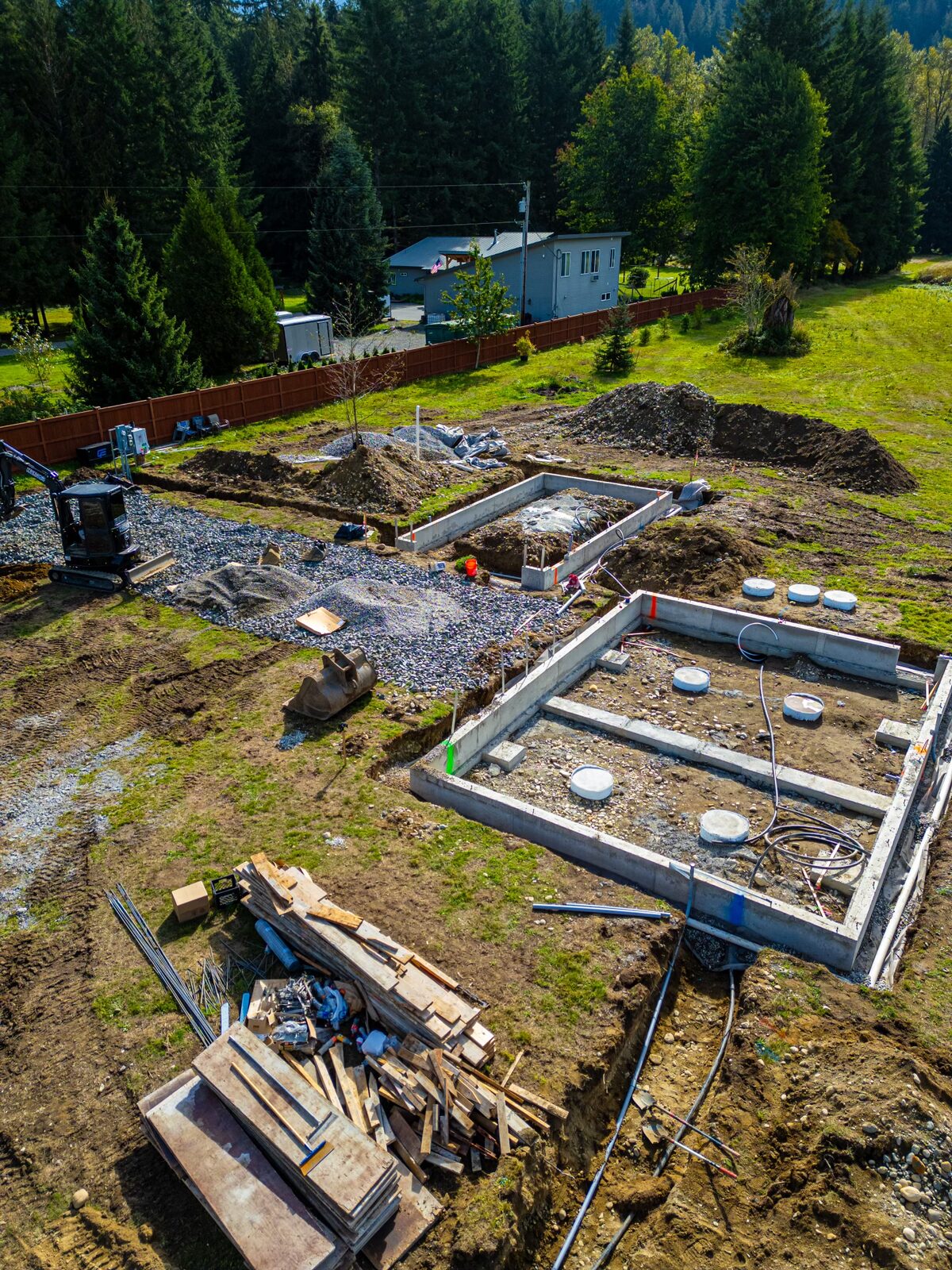 Aerial of a foundation with septic tanks and lumber