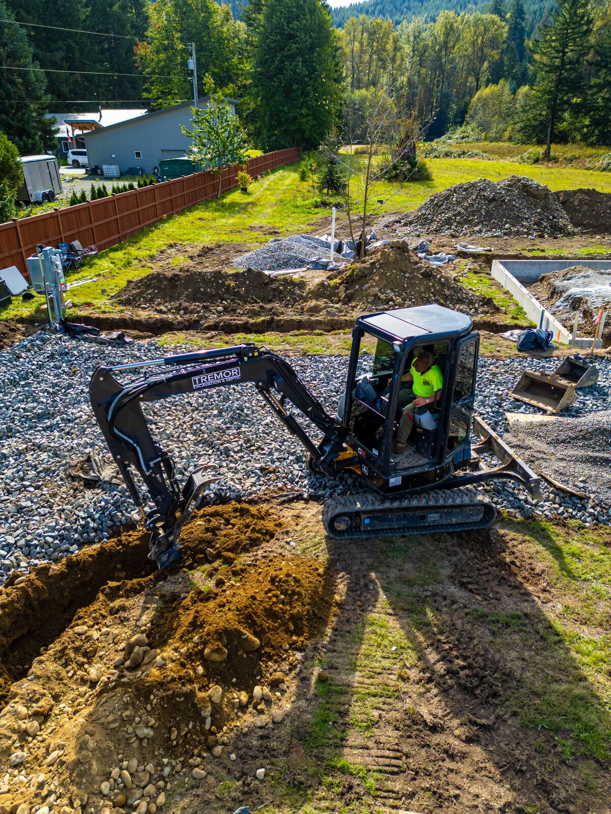 A Tremor Excavation mini excavator at a residential job